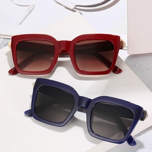 Square oversized sunglasses in red and blue frames with gradient lenses and metal accents