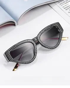 Macro shot of luxury cat-eye sunglasses with rhinestone frames and gradient lenses