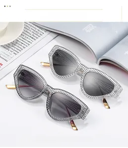 Detail of luxury cat-eye sunglasses featuring high-density rhinestones and gold metal temples