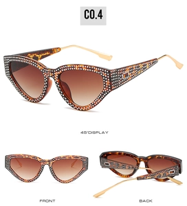 Detailed view of leopard cat-eye sunglasses with rhinestone studs and gradient brown lenses