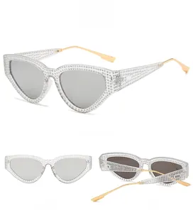 Cat eye sunglasses detail with rhinestone frames and silver reflective lenses