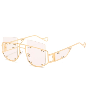 Oversized geometric gold metal sunglasses with silver rivets and clear lenses
