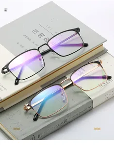 Close-up of black and gold business glasses with blue light coating on books