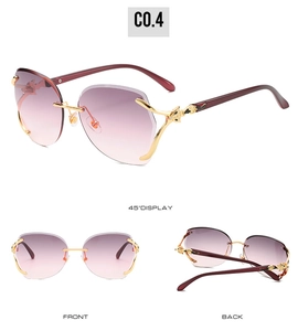 Detail of rimless gradient sunglasses featuring a gold leopard head on the temple hinge