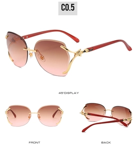 Detail view of rimless butterfly sunglasses with gold hardware and gradient lenses