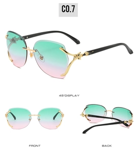 Detail view of rimless gradient sunglasses featuring a gold leopard head on the temple