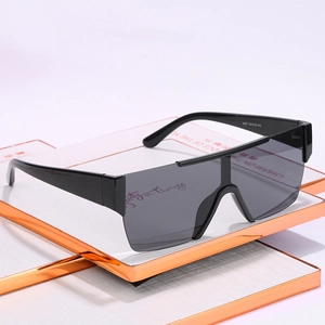 Modern oversized shield sunglasses in glossy black frame with flat top gradient lenses