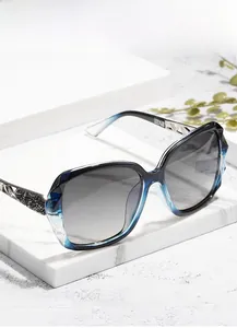 Close-up of oversized gradient frame sunglasses with rhinestone hollow temple detail