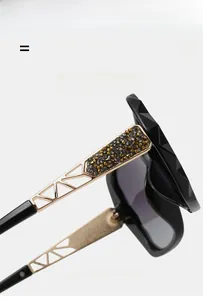 Detail of luxury sunglasses with gold hollow temples and inlaid champagne rhinestones