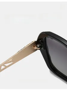 Detail of durable metal hinge on luxury oversized sunglasses with gold temples