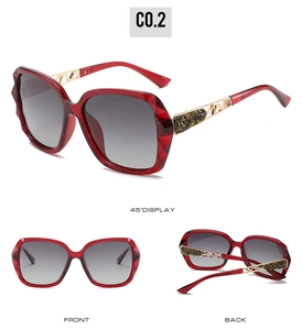 Detail view of large-frame red sunglasses with faceted edges and gold镂空 temple design