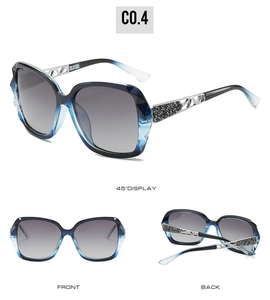 Detail view of large-frame sunglasses with silver metal hollow temples and crystal accents
