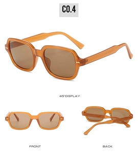 Detail view of square amber sunglasses with gold rivets and brown gradient lenses