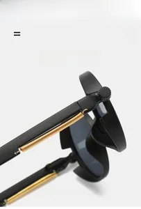 Macro shot of gold metal spring hinges on black steampunk sunglasses for durability