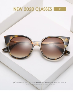 Détail de lunettes de soleil œil-de-chat écaille avec verres dégradés marron