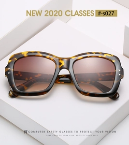 Detail of tortoise shell square frame sunglasses with metal rivet accents and brown lenses