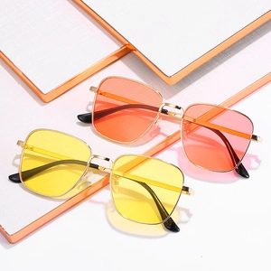 Vintage square metal sunglasses with yellow and orange lenses in a geometric display