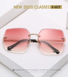 Detail of rimless square sunglasses with pink gradient lenses and gold chain link accents
