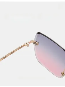 Close-up of golden metal chain temples and durable hinges on rimless gradient sunglasses