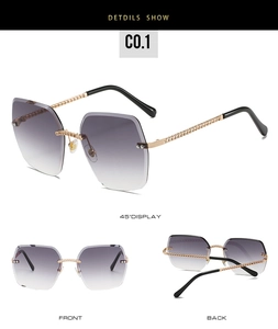 Frameless oversized sunglasses with purple gradient lenses and gold chain temples