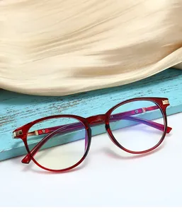 Macro detail of wine red cat-eye glasses frame with blue light blocking lens reflection