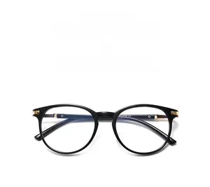 Detail of black round anti-blue light glasses with gold metal hinges and CE certification