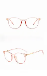 Detailed front and side views of transparent pink cat-eye frames with gold metal accents