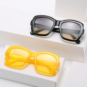 Modern square sunglasses in black and amber frames with gradient lenses for women