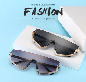 Detailed view of oversized rivet sunglasses in black and purple gradient lenses