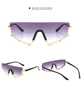 Detail view of oversized shield sunglasses with purple gradient lenses and gold rivets