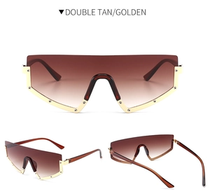 Macro view of oversized shield sunglasses in double tan and golden metal frame
