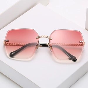Frameless square sunglasses with pink gradient lenses and gold chain textured temples