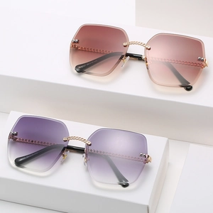 Frameless square sunglasses with gold chain bridge and gradient lenses in purple and brown