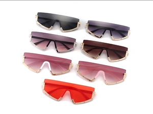 Detail view of multi-color oversized sunglasses with metallic frames and punk rivet accents