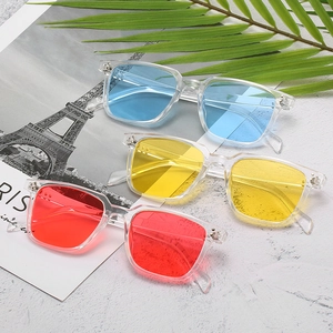 Three pairs of retro square sunglasses with colorful lenses on a vacation background
