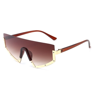 Oversized geometric shield sunglasses with brown gradient lenses and gold metal trim
