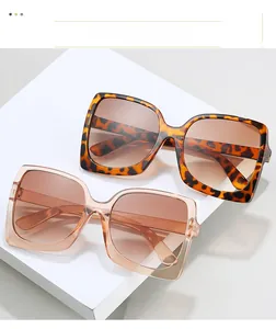 Detailed view of oversized square sunglasses with tortoise and transparent brown frames