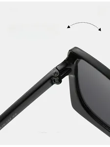 Detail view of durable metal hinge on black oversized square sunglasses frame