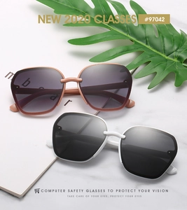 Fashionable hexagonal sunglasses with gradient lenses displayed on marble background