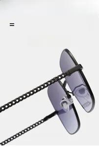 Detailed macro view of the fashion sunglasses showing elegant metal chain woven temples