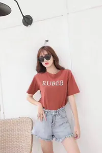Fashionable red t-shirt and frayed denim shorts outfit set worn with oval sunglasses
