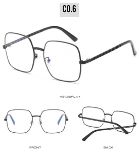 Detail showing oversized black square frame and unique chain texture temples on sunglasses