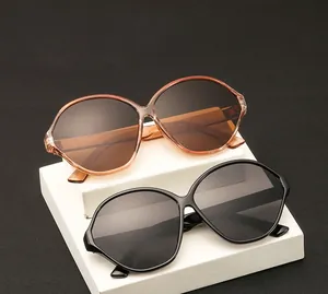 Detail of oversized oval sunglasses with tortoiseshell and black frames on display