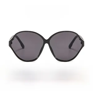 Detailed view of black oval sunglasses with silver metal accents and dark grey lenses