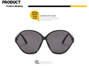 Front view of bright black oversized oval sunglasses with stylish grey lenses