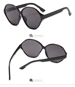 Detail view of large black oval sunglasses showing 45-degree side and back hinge structure