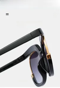 Detail of trendy oversized sunglasses featuring flexible gold metal core and gradient lenses