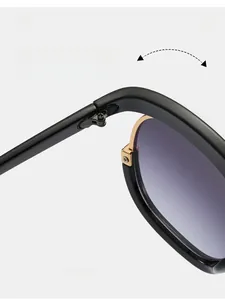 Detail of golden metal hinge on black oversized sunglasses with purple gradient lenses