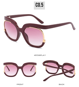 Detail view of wine red oversized sunglasses with pink gradient lenses and gold accents