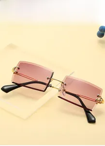 Detail of rimless square sunglasses with pink gradient lenses and gold beaded temples